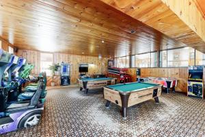 a billiard room with two tables and some chairs at 6B The Seasons in Bartlett