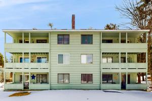 a large white building with snow in front of it at 6B The Seasons in Bartlett