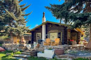a log cabin with a table and chairs in front of it at Bucks House in Jackson