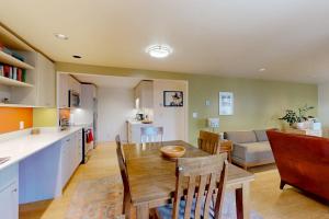 a kitchen and living room with a wooden table and chairs at Tensleep A10 in Teton Village