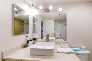 a white bathroom with a sink and a mirror at Tensleep A10 in Teton Village +34 photos