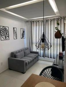 a living room with a couch and a table at Apt Completo com Vista para o Mar, Ar Condicionado e Café da Manhã Opcional in Recife