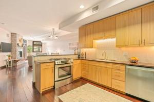 a large kitchen with wooden cabinets and stainless steel appliances at Pearl At Jackson #203 in Jackson