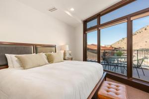 a bedroom with a large bed and a large window at Pearl At Jackson #203 in Jackson