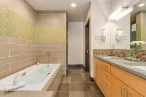 a bathroom with a tub and two sinks at Pearl At Jackson #203 in Jackson +73 photos