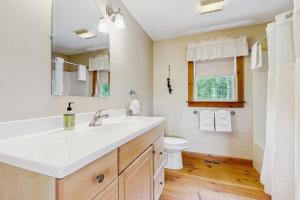 a bathroom with a white sink and a toilet at Chez Normand in Jefferson +37 photos