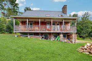 a large house with a deck on a lawn at Chez Normand in Jefferson
