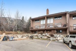 a building with a parking lot in front of it at Windriver Retreat in Teton Village