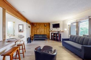 a living room with a couch and a table at Rome Retreat in Waterville Valley