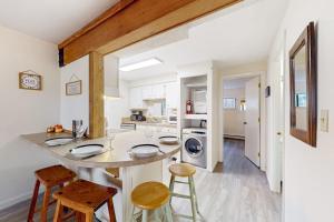 a kitchen with a counter and stools in a room at Rome Retreat in Waterville Valley
