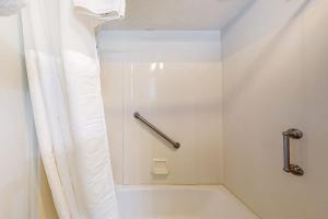 a white bathroom with a shower with a shower curtain at Rome Retreat in Waterville Valley +51 photos