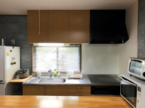 a kitchen with a sink and a microwave at 北軽井沢 SPAHA Karuizawa Forest Resort Villa YB1 in Kita-karuizawa