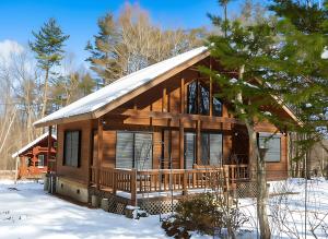a log cabin in the snow in the woods at 北軽井沢 SPAHA Karuizawa Forest Resort Villa YB1 in Kita-karuizawa