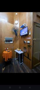a room with a table and a tv on a wall at Sip N' Camp in Bangkok +18 photos