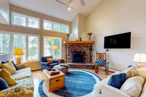 a living room with a couch and a fireplace at Lake View by the Mountain in Bridgton