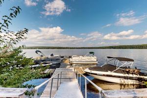 a group of boats docked at a dock on a lake at Lake View by the Mountain in Bridgton