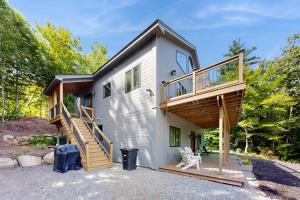 a house with a staircase and a deck at Ferncrest Mountain House in Conway