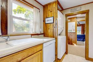 a kitchen with a sink and a washer and dryer at Seaside Cottage in Wells +45 photos