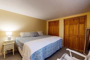 a bedroom with a bed and a table with a night stand at The Good Knight in Bridgton +42 photos