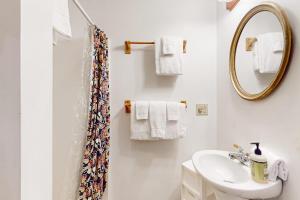 a white bathroom with a sink and a mirror at Moose Haven in Denmark +70 photos