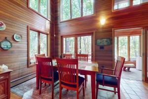 a dining room with a table and chairs and windows at Writer's Retreat in Wells