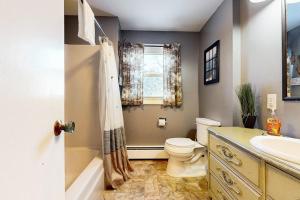 a bathroom with a sink toilet and a window at Welcome Home in North Conway +43 photos