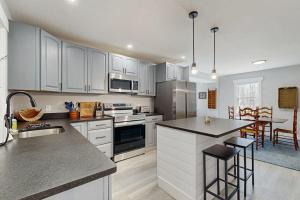a kitchen with white cabinets and a counter top at Eagle's Nest in Bridgton