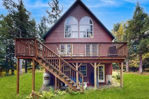 a house with a large deck on the side of it at Bethel Peak Escape in Bethel