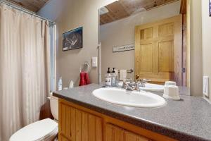 a bathroom with a sink and a toilet and a mirror at Bethel Peak Escape in Bethel +34 photos