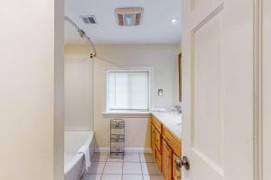 a bathroom with a tub and a sink and a bath tub at Kendall Brooke in North Conway