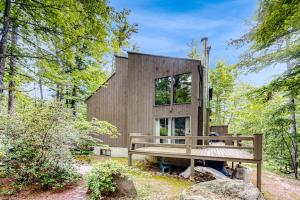 a tiny house in the woods with a bench at Snowy Peaks Hideaway in Conway