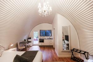a room with a bed and a chandelier at Romantic Couples Retreat in Mount Tamborine