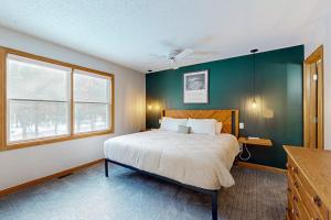 a bedroom with a bed and a green wall at The Evergreens in North Conway