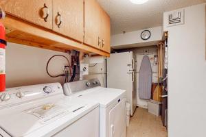 a small kitchen with a white washer and dryer at The Evergreens in North Conway +41 photos
