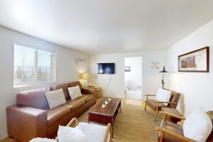 a living room with a couch and a table at Tensleep B11 in Teton Village