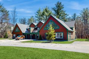 a red house with a car parked in front of it at Cranmore Road 7 in North Conway