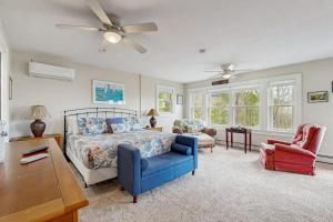 a bedroom with a bed and a blue chair at The Betty in Jackson