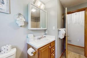a bathroom with a sink and a toilet and a mirror at Wiggly Bridge Landing in York Harbor +43 photos