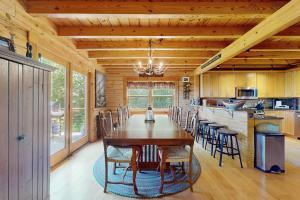 a dining room with a wooden table and chairs at Bearly Behaving Lodge in Sugar Hill