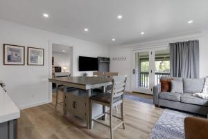 a kitchen and living room with a table and a couch at Spruces 11 in Wilson