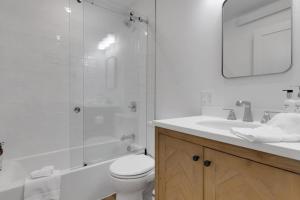 a bathroom with a shower and a toilet and a sink at Spruces 11 in Wilson +31 photos