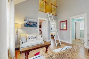 a living room with a couch and a ladder at Coral Drift Cottage in Wells +42 photos