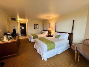a hotel room with two beds and a television at Oceanview Studio at Kauai Beach Resort #2444 in Lihue