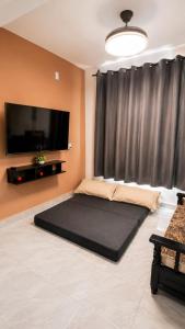 a bedroom with a large bed and a flat screen tv at Departamentos Aurora in Tuxtla Gutiérrez