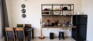 a kitchen with a table and a black refrigerator at Departamentos Aurora in Tuxtla Gutiérrez