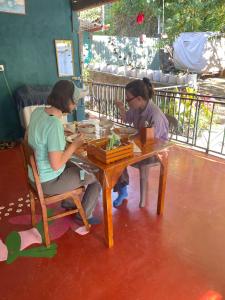 two women sitting at a table in a restaurant at Thumb Up Family Rest in Haputale +78 photos