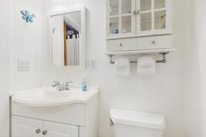 a white bathroom with a sink and a toilet at North Lynx 8 in Warren +28 photos