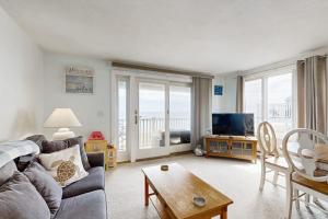 a living room with a couch and a tv at Beachfront Memories in Old Orchard Beach