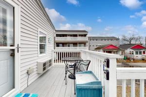a white balcony with a table and chairs on it at Hampton Beach Hangout in Hampton