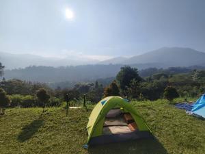 a tent on top of a hill with a view at Thursina Camping Ground in Paragajen